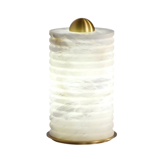 The Aurelior LED Large Ribbed Alabaster Table Lamp – Soft White features a cylindrical, textured white ribbed design with horizontal ridges, topped with a smooth dome-shaped gold cap and matching base. It emits a soft, diffused LED light.