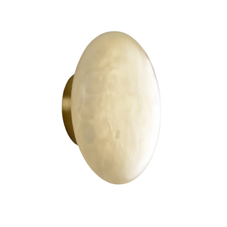 The Solenne LED Small Halo Alabaster Wall Light features a smooth soft white alabaster shade and a brass base, shown from an angle against a white background.