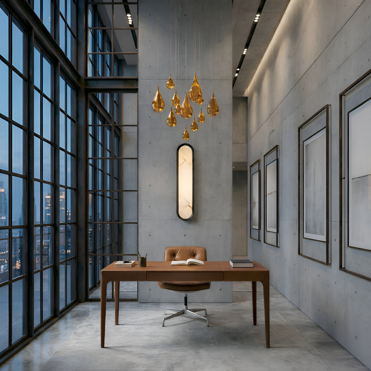 Modern office with high ceilings, floor-to-ceiling windows, wooden desk, brown swivel chair, Aurex LED Vertical Alabaster Wall Light in soft white & matte black, amber pendant lights, concrete walls, framed art. Open book and pen on the desk.