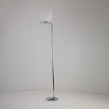 The Vetra 1 Light Opal Glass Floor Lamp in grey features a slim chrome stand and an opal glass sphere shade at the top, offering soft ambient lighting against a plain white background.