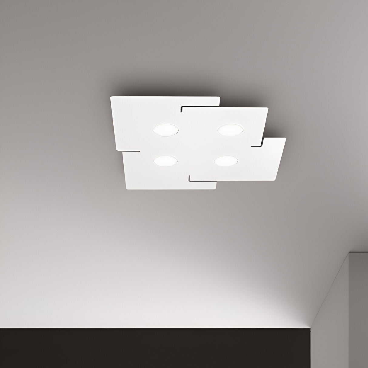 The Emberix 4 Light Ceiling Light in white is a modern ceiling fixture with a minimalist square design, featuring four symmetrically arranged recessed circular lights. This eco-friendly lighting option includes energy-efficient bulbs and offers a sleek matte finish.