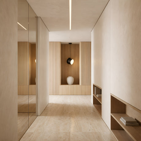 Minimalist hallway with beige walls and floors, a built-in shelf with books on the right, mirrored panels on the left, and a decorative alcove at the end with a ceramic vase under a spotlight. The Mono LED Pendant Light - Black adds modern style overhead.