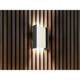 The Matia Outdoor LED Wall Light 18W 3000K in Dark Grey features a modern rectangular design and emits soft, warm light between slats, creating a stylish ambiance—ideal for sophisticated outdoor spaces.