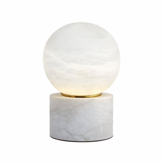 The Aurion LED Small Globe Alabaster Table Lamp features a glowing soft white glass globe on a cylindrical alabaster base, highlighted by a slim gold accent between the sections.