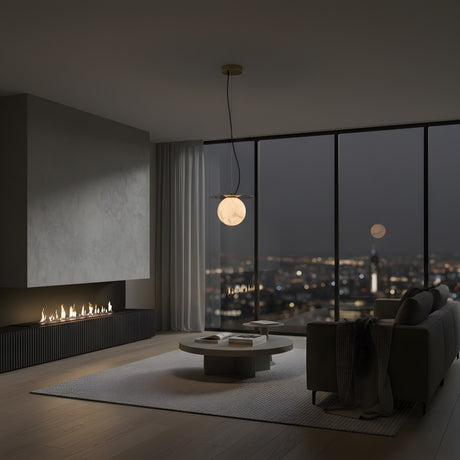 A modern living room at night features minimalist furniture, a round coffee table, and floor-to-ceiling windows with city views, softly lit by the Marenzo 1 Light Small Orb Alabaster Single Pendant Light in Soft White & Brushed Brass beneath the full moon.