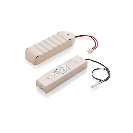 Two beige devices with wires are part of the Emergency Light Kit For LED Modules. One device has a ribbed rectangular appearance similar to an emergency lighting module, while the other is more elongated and includes a label with text. Both devices are equipped with connecting wires that terminate in small white connectors.