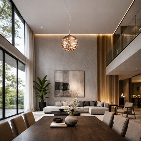 A modern living and dining area with high ceilings, large windows, a dark wood table, beige chairs, and a cozy sectional is beautifully lit by the Elon LED Single Pendant - Copper and natural light for an elegant ambiance.