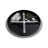 A circular light fixture lies face down, exposing its inner components. Visible are a metallic support frame, wiring, and electrical elements. The fixture combines modern elegance with its round, gold edge and smooth surface, reminiscent of the Fluxa 3 Light LED Cluster Pendant 3000K 60W - Gold.