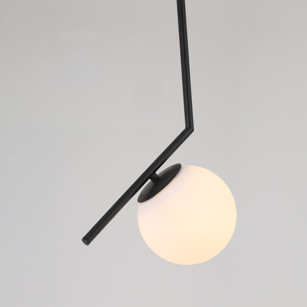 The Vetra Opal Glass Large Pendant Light - Black features a black angular rod and a round, frosted white glass globe, offering sleek contemporary style ideal for modern interiors.