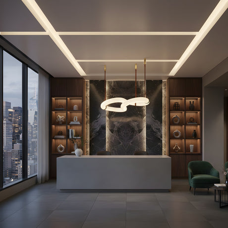 A modern reception area features a sleek white desk, decorative shelves, city views, and a green chair by flowers. Overhead, the Serava LED Small Alabaster Loop Suspension Light in Brown & Soft White adds elegant style.