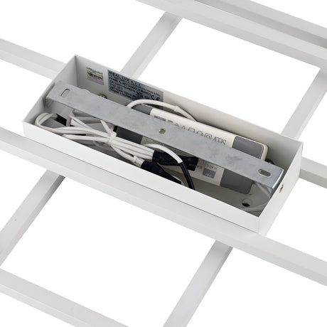 A detailed view of the wiring and electrical component housing of the Prios LED Ceiling Light 31W 3000K - White from IKEA. The metal and plastic components are neatly arranged inside a rectangular box, revealing wires and circuit details. This setup is encased in a grid structure, enhanced by opal-colored diffusers for a minimalist design.
