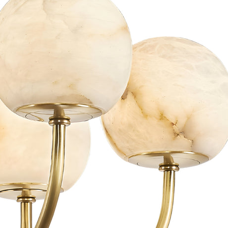 Close-up of three creamy white and beige marbled globes on curved stems, showcasing the elegant Aurelio 10 Light Large Globe Alabaster Chandelier in soft white and brushed brass.