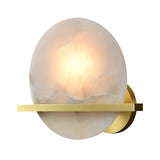 The Caldris LED Circular Alabaster Wall Light in brushed brass and soft white features a round alabaster shade and gold base, offering elegant, contemporary lighting that adds a modern touch to any room.