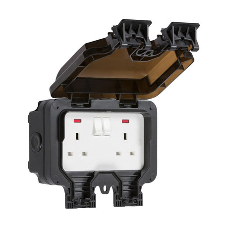 An IP66 rated outdoor twin power socket featuring a double outlet and an open, protective black cover. The polycarbonate hinged cover is water-resistant and specifically engineered to protect the outlets from environmental factors. This product is called the IP66 13A 2 Gang DP Switched Socket Neons.