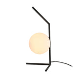 The Vetra 1 Light Opal Glass Table Lamp - Black features a modern black angular metal frame with a round frosted opal glass globe as its light source, and includes a cord that extends from the base.