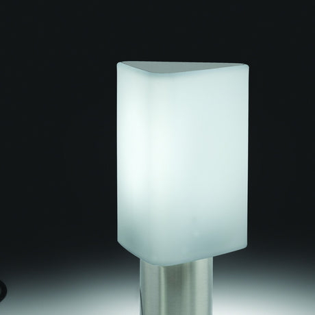 Tiny Triangle Table Lamp in Satin Nickel, with a glowing white plastic triangular shade and rounded corners on a slim cylindrical metal base, shown against a dark background.