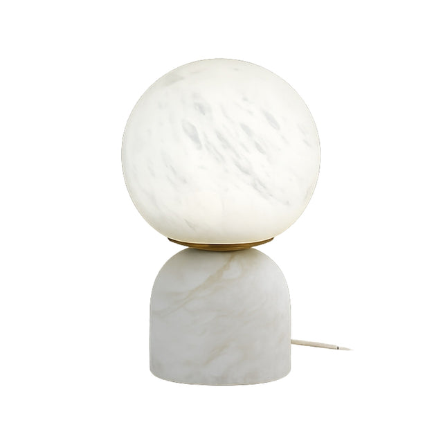 The Solvyn LED Small Globe Alabaster Table Lamp – Soft White features a round, frosted glass globe on a smooth cylindrical alabaster base with subtle veining and includes a power cord at the back.