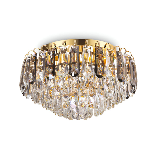 The Flair 7 Light Crystal Chandelier - Gold boasts a luxurious circular design with an enchanting array of pendants. Its golden fixture and brilliantly reflective crystals create a captivating sparkle.