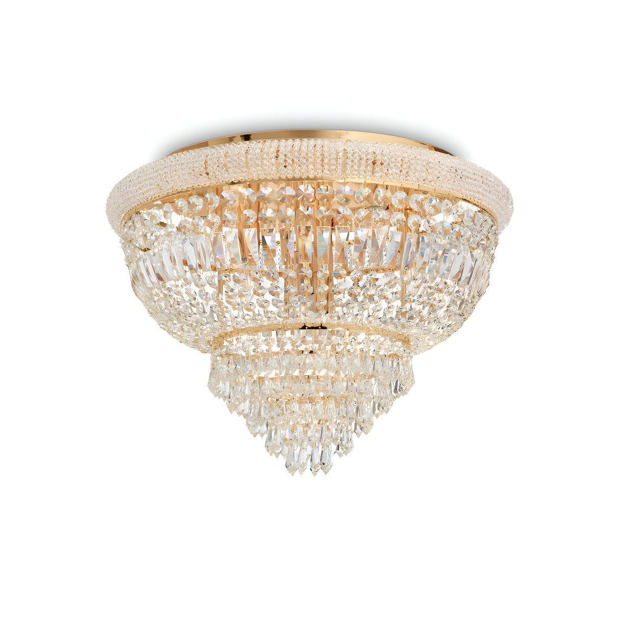 The Emberlit 24 Light Crystal Chandelier - Brass is an opulent fixture with multiple tiers of hanging crystals and a captivating brass finish, displayed against a simple white backdrop. This circular chandelier boasts intricate detailing and offers dimmable lighting, casting stunning reflections.