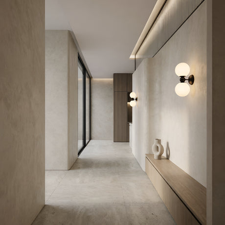 Minimalist hallway with beige stone walls and floors, built-in wooden bench with vases, floor-to-ceiling window, vertical wood accent wall, and Vetra 2 Light Opal Glass Wall/Semi-Flush Ceiling Light in black for modern illumination.