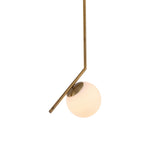 Niori Vetra Opal Glass Small Pendant Light in gold, with a bent brushed gold stem cradling a white opal glass globe against a plain background.