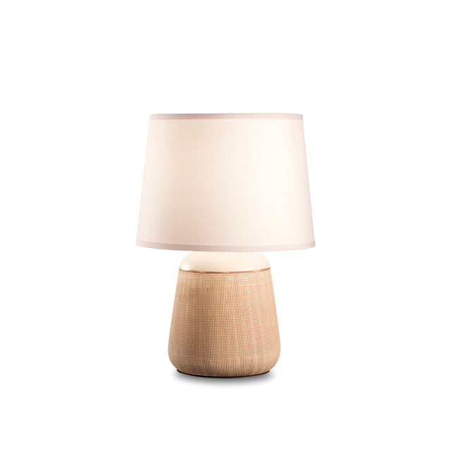 The Glimmerlux Table Lamp - Cream is designed with a white fabric shade and a textured, cylindrical wooden base, all set against a plain white background to provide warm illumination to any space.