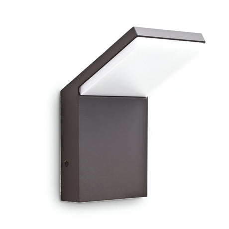 The Brillix Outdoor LED Wall Light 9W 3000K in Anthracite boasts a modern, minimalist design with a geometric style. Its durable metal base and angled top contribute to its sleek, contemporary appearance. The fixture provides energy-efficient illumination with an off-white light contrasted by a dark border, making it ideal for any setting.