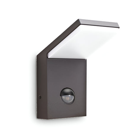Introducing the Brillix Outdoor Motion Sensor LED Wall Light 9.5W 3000K in Grey, a contemporary wall-mounted lighting solution that combines a sleek, angular design with energy efficiency. Featuring a rectangular base and an extended flat white panel, this fixture not only illuminates your exterior space with its LED light but also enhances its aesthetics with style and functionality.
