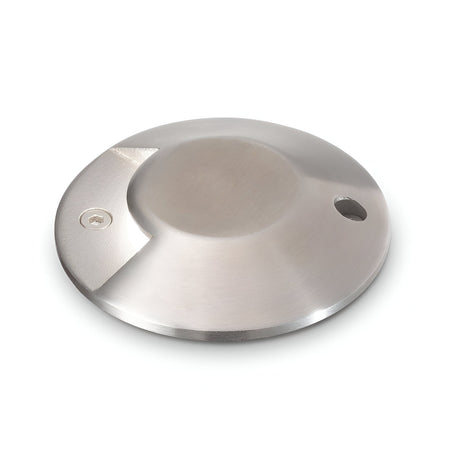 Introducing the Gleamora-1 LED Outdoor Drive Over Recessed Ground Light 3W 3000K in Grey: a round and flat fixture with a sloped edge, expertly designed for floor mounting. Featuring an IP65 rating for exceptional durability, this stainless steel light with a brushed finish includes a small hole on one side and showcases a stamped icon on the opposite side.