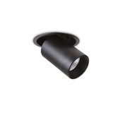 The Solis LED Single Recessed Spotlight 12W in black features a cylindrical design with a downward-facing spotlight, providing adjustable lighting. When installed in a white ceiling and partially embedded, it presents a sleek and modern appearance while emitting a warm glow at a 3000K color temperature.