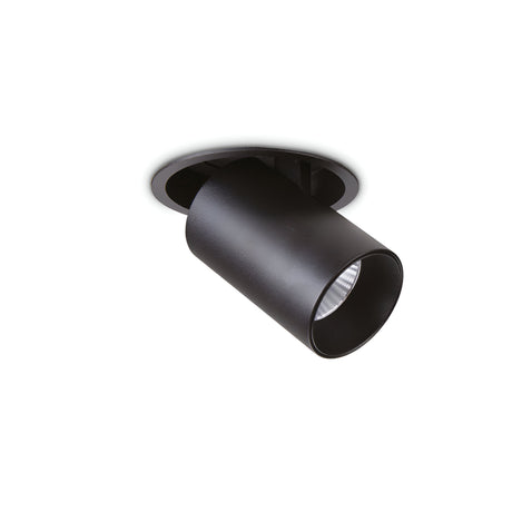 The Solis LED Single Recessed Spotlight 12W in black features a cylindrical design with a downward-facing spotlight, providing adjustable lighting. When installed in a white ceiling and partially embedded, it presents a sleek and modern appearance while emitting a warm glow at a 3000K color temperature.