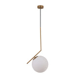 Niori Vetra pendant light with a 30cm opal glass globe offset on an angled brushed gold metal arm and ceiling fixing, shown on a white background.