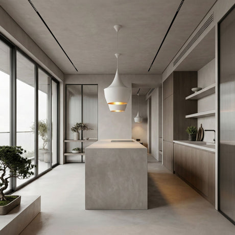 Minimalist modern kitchen with light gray walls and floors, sleek island, wood cabinetry, open shelves, and large windows. Two Funk Fat Pendant Light - White fixtures add style overhead, while a small bonsai sits near the window.
