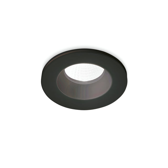 The Omera LED Round Recessed Downlight 8W 3000K - Black, with its modern circular design and sleek black finish, softly illuminates the center against a plain white background.