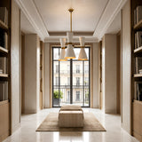 A modern hallway with marble floors, built-in wooden shelves, a large window with city views, a beige bench on a rug, and the Ramses 3 Light Chandelier - White overhead.