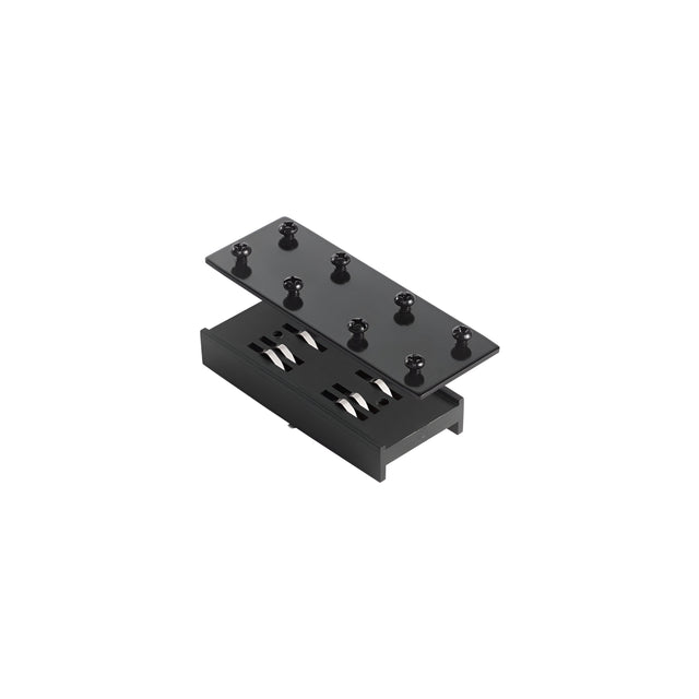The Prismatic Linear Track Connector - Black displays a sleek, minimalist design with its black rectangular box and detachable lid featuring multiple cylindrical pegs, reminiscent of a modern track lighting connector. Inside, it reveals two parallel cylindrical components that continue the elegant black finish of the track connector style.