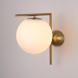The Vetra 1 Light Opal Glass Wall/Semi-Flush Ceiling Light in gold features a round opal glass shade and brass fixture, adding elegance to any light-colored wall.