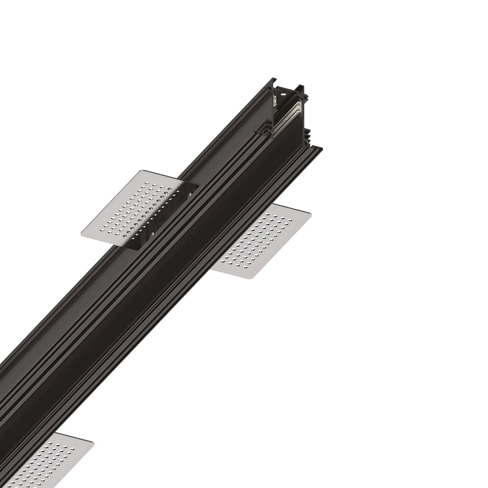 A close-up view of the Luxeon-1 Recessed Magnetic Track 1m in black, showcasing its perforated side panels and multiple grooves and ridges, reminiscent of modern track lighting, set against a white background.