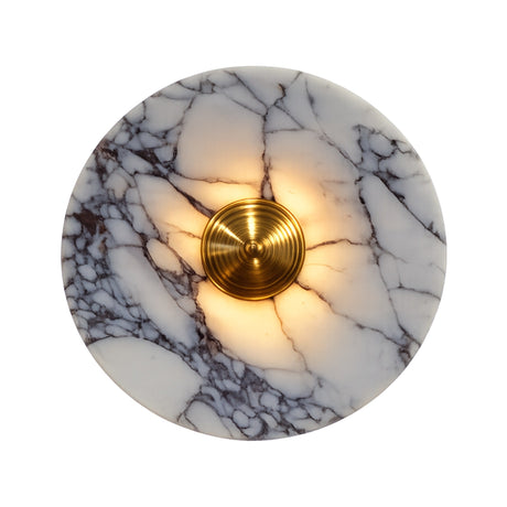 The Carrara LED Medium Veined Disc Marble Wall Light features white and black veined marble with a glowing brushed brass center, casting warm LED light outward from the middle.