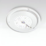 A close-up of the Mirage LED Ceiling & Wall Light 22.5W 3000K – White, 40cm showcases its energy-efficient illumination with multiple small bulbs arranged in a circular pattern. This versatile fixture seamlessly integrates with the flat white ceiling, combining modern design with functionality.