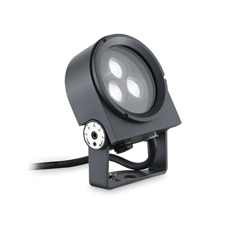 The Lucellalis Outdoor LED Single Spotlight 8.5W 3000K in grey features a modern and industrial design with an adjustable mounting bracket and a black cable. Its IP65 Protection Rating ensures durability, while the warm 3000K light is perfect for outdoor or architectural lighting needs.