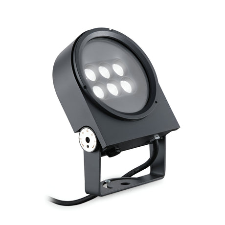 The Lucellalis Outdoor LED Single Spotlight 15W 3000K in grey is a black, industrial-style outdoor floodlight featuring a circular array of six lights in a rectangular frame, mounted on an adjustable bracket. Designed for flexible lighting, its sleek modern design offers durability with IP65 protection and includes a power cord extending from the base.