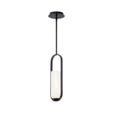The Eliona 1 Light Capsule Alabaster Single Pendant Light in matte black and soft white hangs from the ceiling with a metal frame, showcasing a cylindrical white shade encased in an oval loop. The background is plain white.