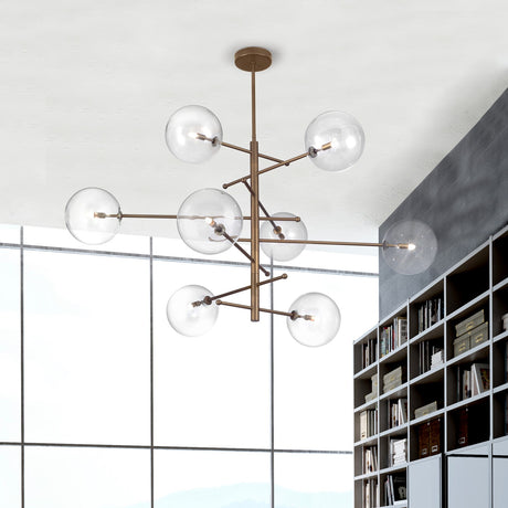 Estro 8 Light Globe Glass Chandelier 130cm in bronze-finish metal with clear glass globe shades, shown suspended from a white ceiling in a room with a bookshelf and window.