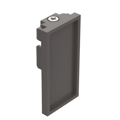 A black rectangular object with a recessed center features a small circular component adorned with a bee design on top. Its flanged edges indicate that it is the Luxeon-2 End Power Cap for 3-Phase Track lighting.