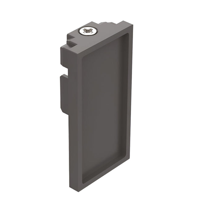 A black rectangular object with a recessed center features a small circular component adorned with a bee design on top. Its flanged edges indicate that it is the Luxeon-2 End Power Cap for 3-Phase Track lighting.