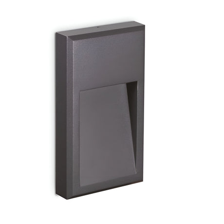 Introducing the Arcana-2 LED Outdoor Wall Light 6W 3000K in Grey: a sleek, rectangular fixture with a minimalist design, made from durable powder-coated die-cast aluminum. It features a slightly recessed section for a modern, geometric look and provides energy-efficient lighting with lasting durability.