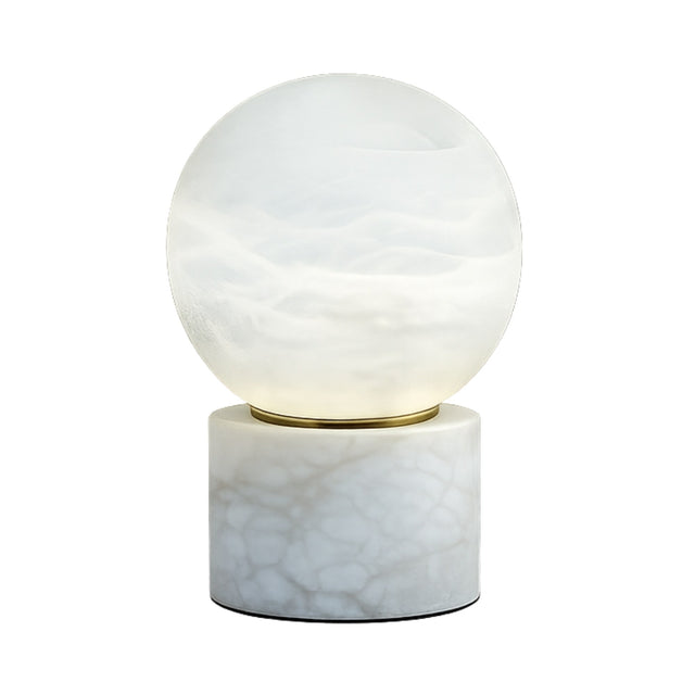 The Aurion LED Large Globe Alabaster Table Lamp features a modern, round soft white glass globe on a cylindrical alabaster base with natural veining.