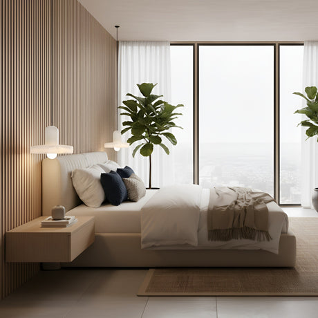 A modern bedroom with a large bed, neutral bedding, wood panel wall, floating nightstands, indoor plants, and the Ophira 1 Light Small Disc Alabaster Single Pendant Light in soft white. Floor-to-ceiling windows showcase a calming city view.