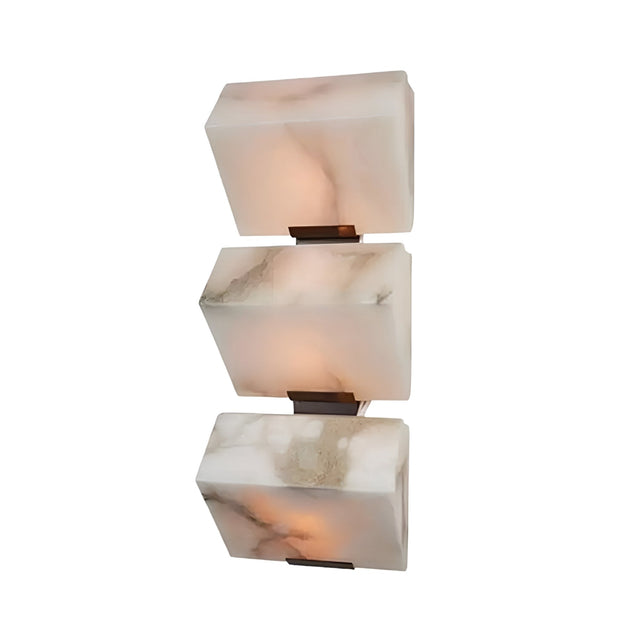 The Glorina LED Large Stacked Alabaster Wall Light – Soft White features vertically stacked rectangular alabaster panels with soft lighting, mounted with small metal brackets for a refined white backdrop.